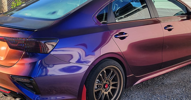 Custom color-shift vinyl wrap on sports car with gloss and metallic finish