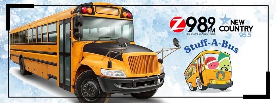 Yellow school bus with Stuff-A-Bus logo and 98.9 FM, New Country 95.5 branding on a snowy background.